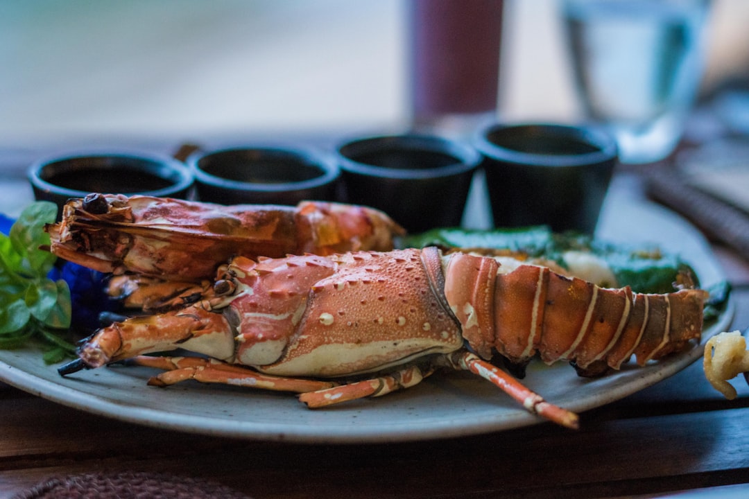 A group of friends share lobster rolls and drinks at a casual New York City seafood restaurant in summer.