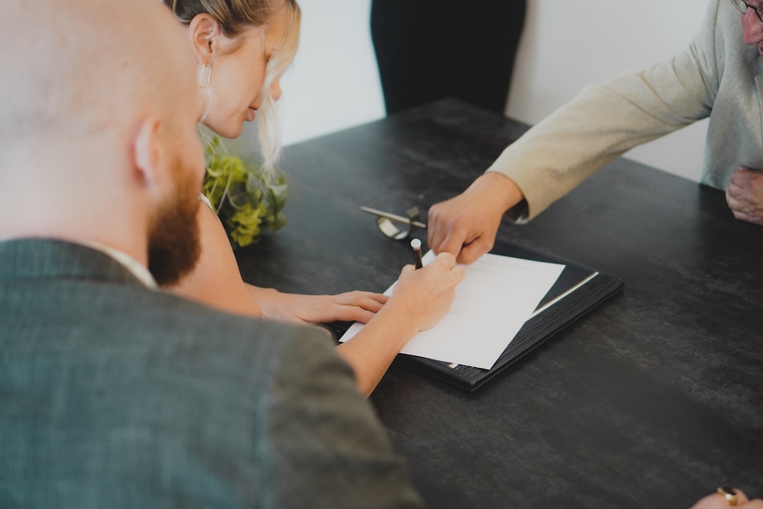 A business owner signs permit paperwork as part of launching his small business in New York City