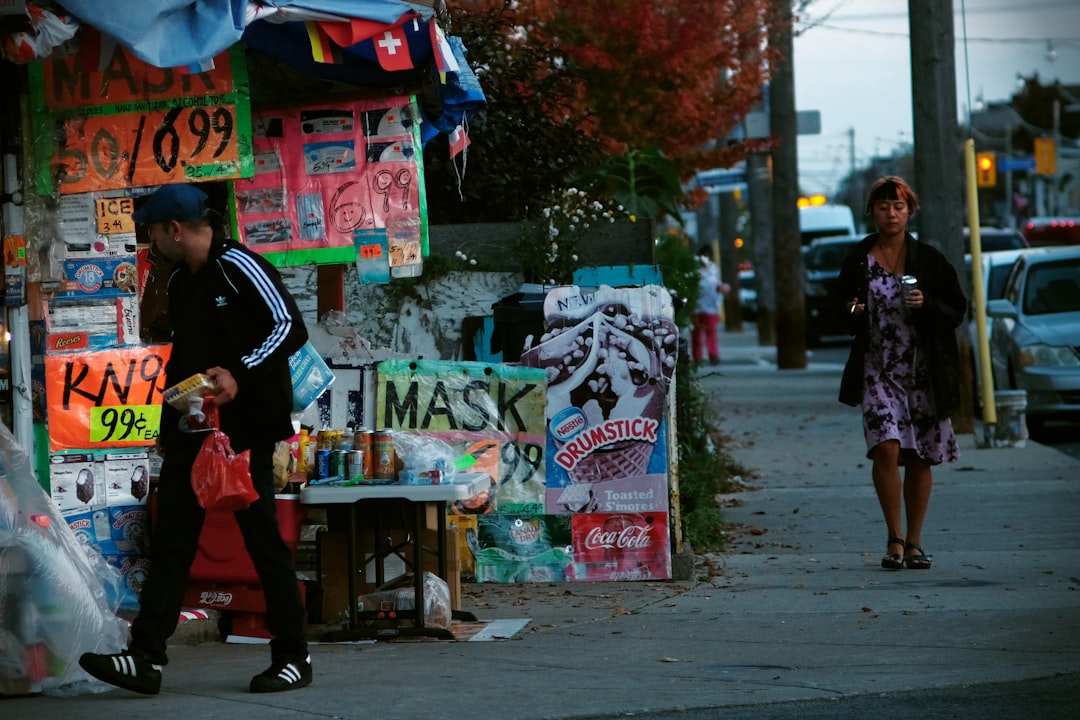 Vendors and shoppers interact at a busy street market run by immigrant businesses in a New York City neighborhood