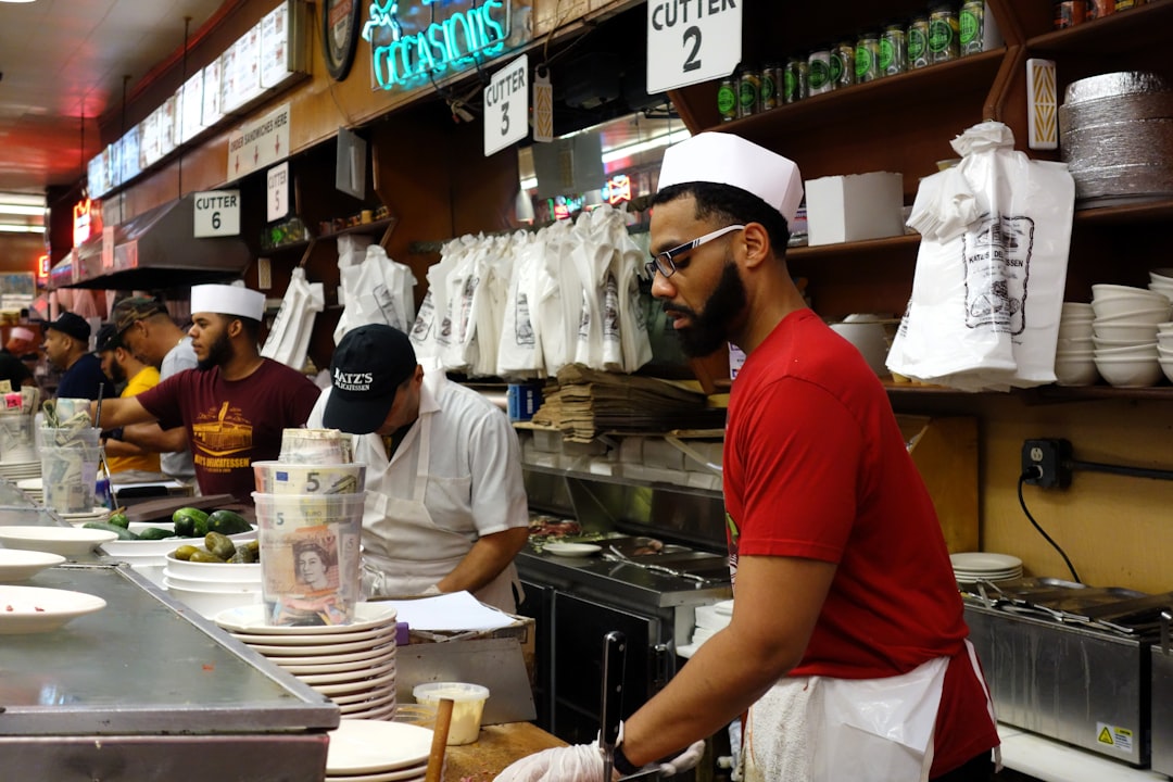 A cook prepares food in a small restaurant, one of thousands of immigrant businesses that feed New York City every day
