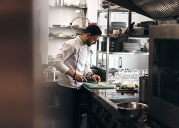 A food entrepreneur preparing products in a shared commercial kitchen space in New York City