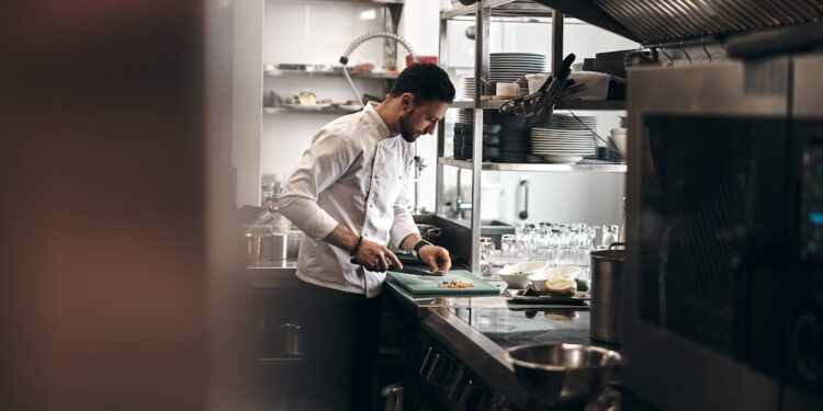 A food entrepreneur preparing products in a shared commercial kitchen space in New York City