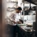 professional-kitchen-cooking-unsplash - NYCwebzine A food entrepreneur preparing products in a shared commercial kitchen space in New York City