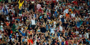 soccer-fans-cheering-bar-crowd-unsplash - NYCwebzine Excited soccer fans cheering together at a New York City bar during a World Cup match screening