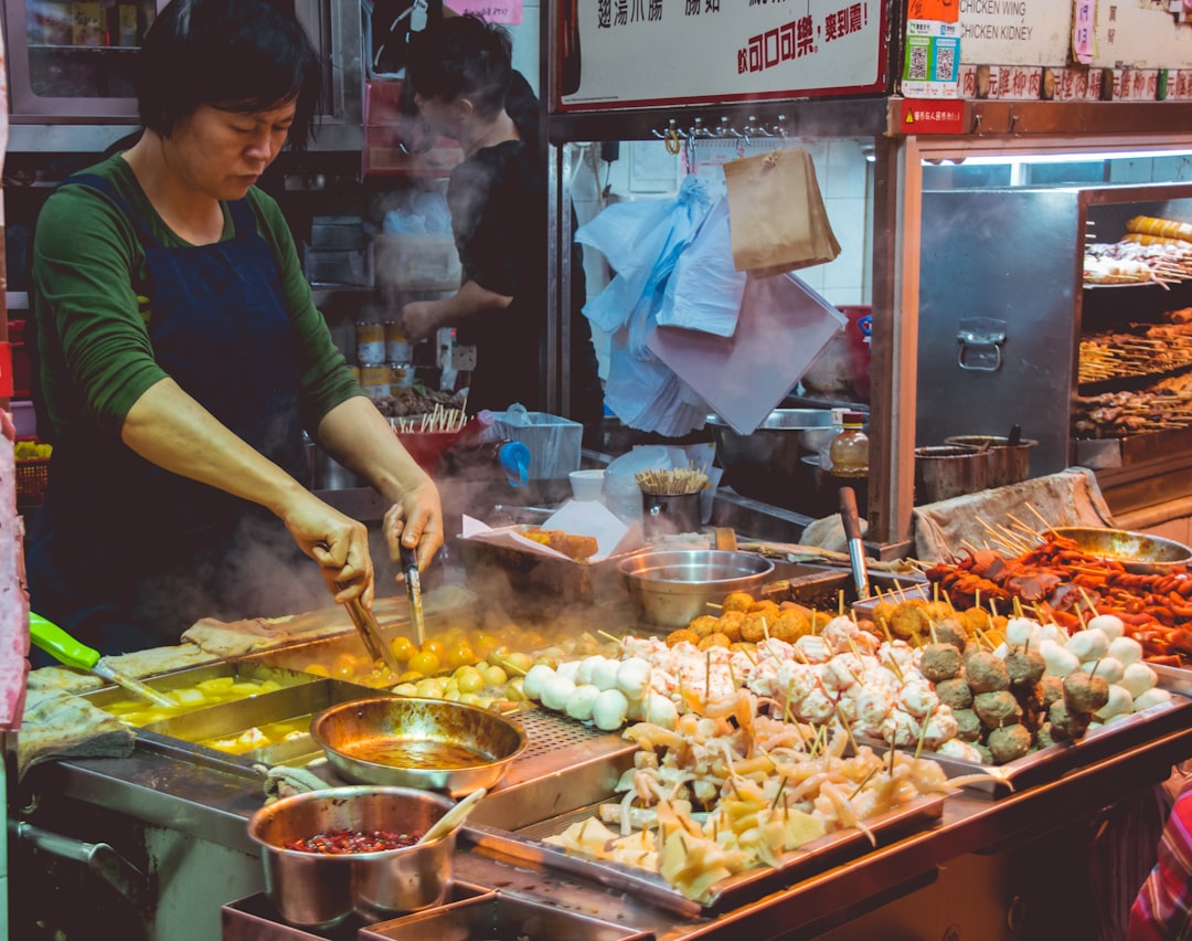A street food vendor prepares fresh jianbing at an outdoor stall in Flushing Chinatown