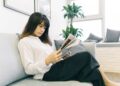 A woman reviewing a lease agreement as NYC rents continue to rise in a Manhattan apartment building