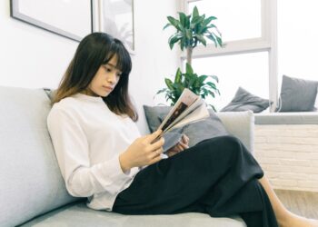 A woman reviewing a lease agreement as NYC rents continue to rise in a Manhattan apartment building
