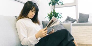 A woman reviewing a lease agreement as NYC rents continue to rise in a Manhattan apartment building