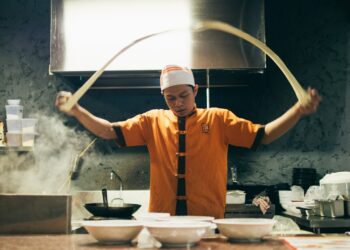 chef-serving-ramen-bowl-unsplash - NYCwebzine A chef carefully serves a steaming bowl at one of New York City's most celebrated ramen shops