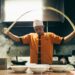A chef carefully serves a steaming bowl at one of New York City's most celebrated ramen shops