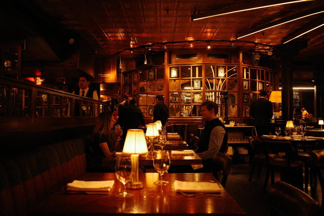 A smiling couple enjoys a prix-fixe dinner together inside a beautifully lit New York City restaurant during restaurant week.