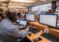 engineer-working-in-a-center-unsplash - NYCwebzine Engineers working on New York power grid highlighting data center moratorium energy concerns, max 100 chars