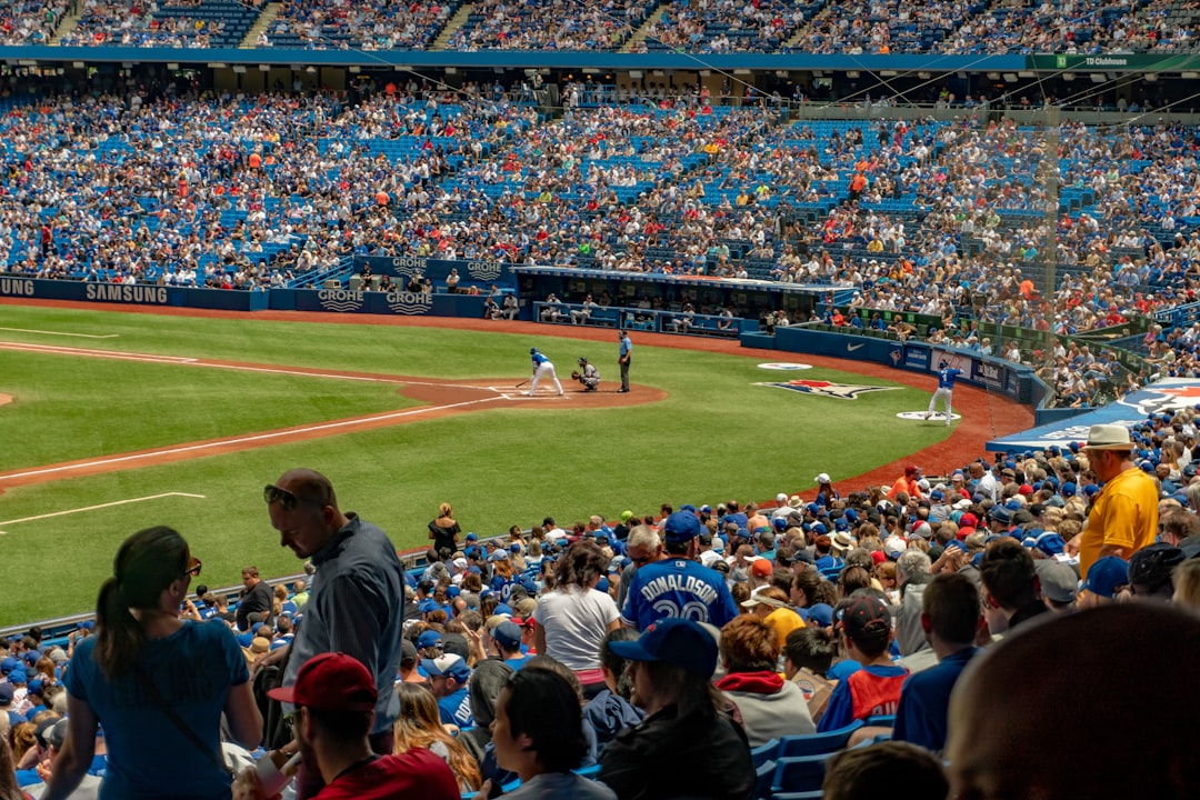 A family sharing snacks in their seats at a stadium after buying affordable baseball tickets for a summer game