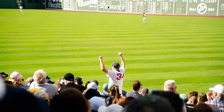 fan-cheering-baseball-stadium-crowd-unsplash - NYCwebzine A smiling fan cheering in the upper deck while watching a baseball tickets game on a sunny summer afternoon