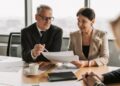 A financial advisor discusses the pied-à-terre tax with a client in a Manhattan luxury apartment