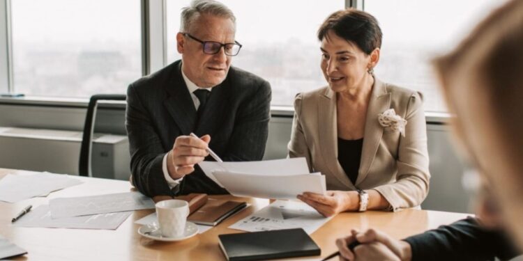 A financial advisor discusses the pied-à-terre tax with a client in a Manhattan luxury apartment