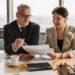 financial_advisor_client_with_papers_in_luxury_apartment - NYCwebzine A financial advisor discusses the pied-à-terre tax with a client in a Manhattan luxury apartment