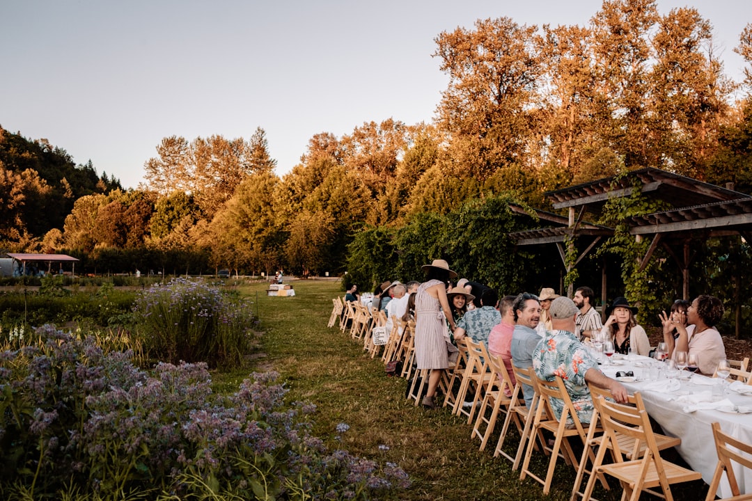 A group of friends enjoy a farm-to-table outdoor meal during a summer Hudson Valley weekend away from New York City