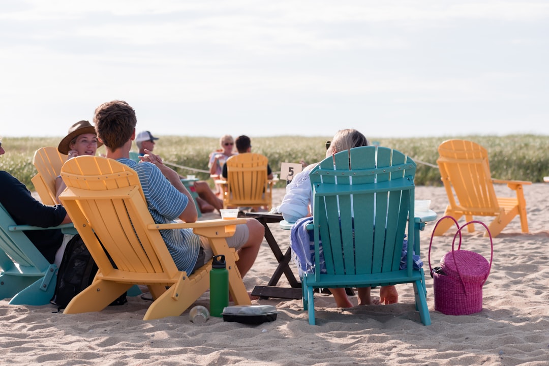 A group of friends enjoys fresh seafood at a waterfront restaurant in one of Connecticut's beloved coastal towns near NYC.