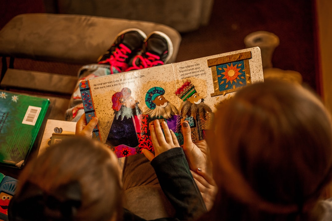 A librarian leads a storytime session at a children's bookstore in NYC, with kids sitting together on the floor listening.