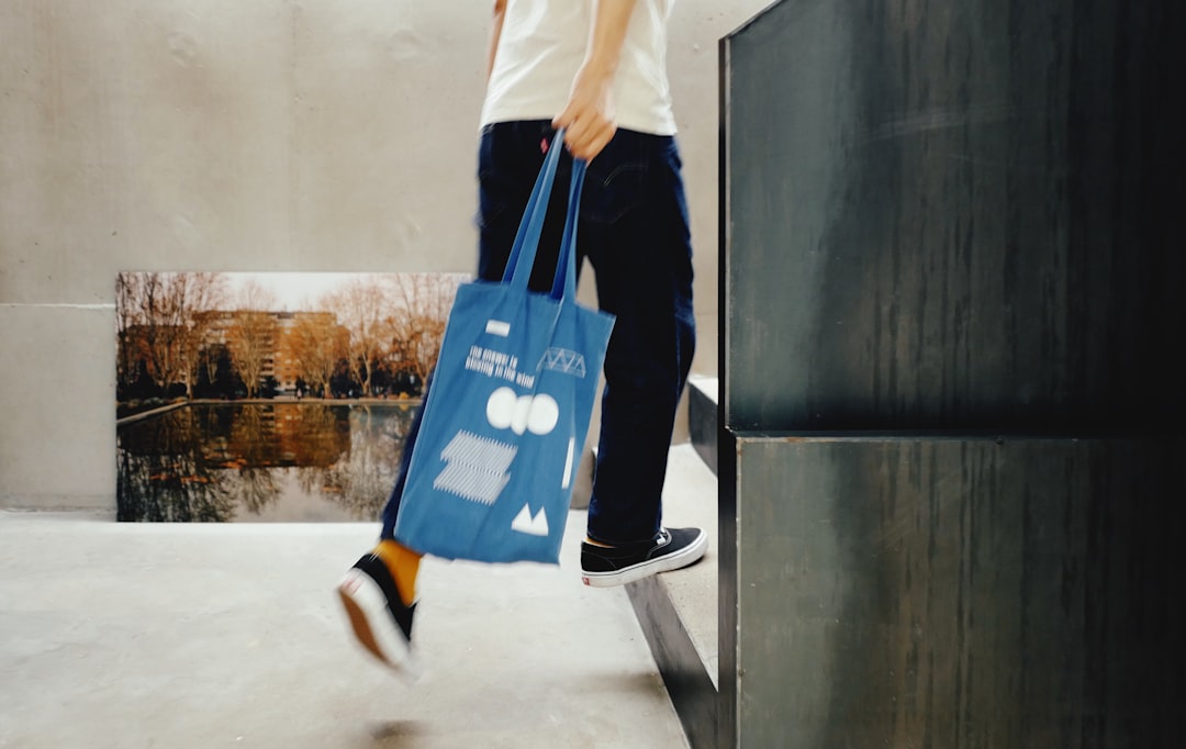 A man using a reusable bag at a New York City market to reduce household waste at the source