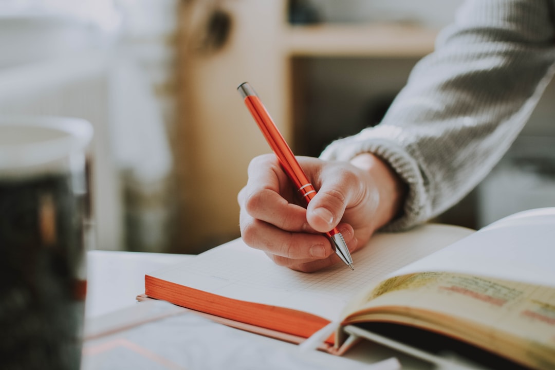 A person writing in a journal as part of a mindful morning routine in a compact city kitchen
