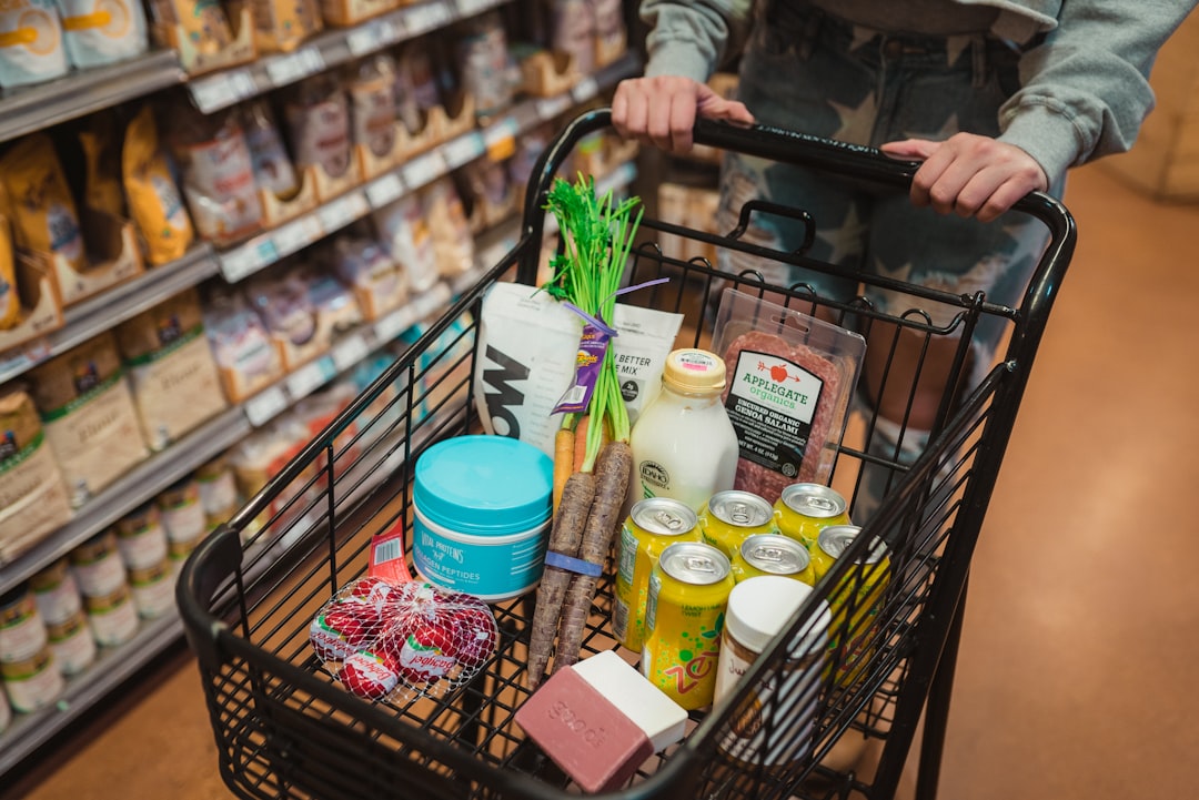 A shopper selects bulk pantry staples at a zero waste grocery store, bringing her own reusable containers to reduce plastic.