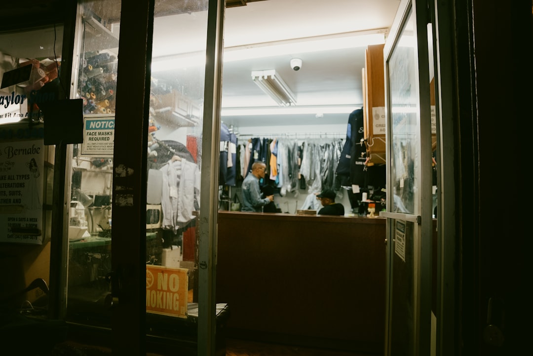 A shopper holds up a garment while exploring vintage clothing at a New York City thrift boutique