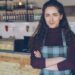 A small business owner stands in front of her New York City shop, reviewing everything to keep her small business thriving.