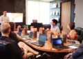 startup-founder-investor-meeting-unsplash - NYCwebzine A startup founder presenting to her first investor in a New York City office, with a pitch deck visible on screen