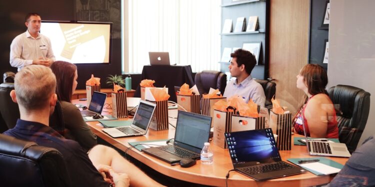 A startup founder presenting to her first investor in a New York City office, with a pitch deck visible on screen