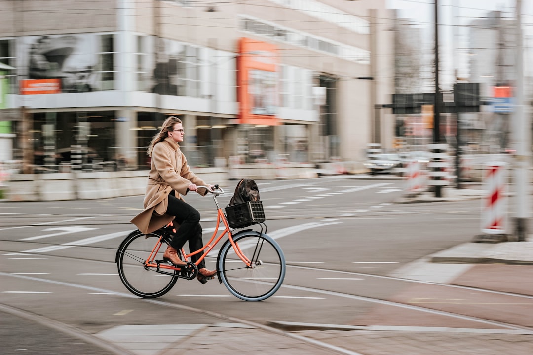A cyclist rides along a protected Brooklyn bike lane, illustrating the growing cycling culture that supports car-free living.