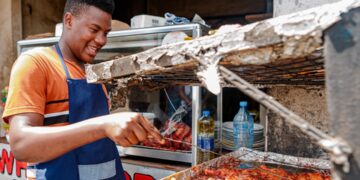 west-african-food-restaurant-unsplash - NYCwebzine A West African man serves a bowl of fufu and soup at a busy Bronx restaurant, representing the heart of the West African food