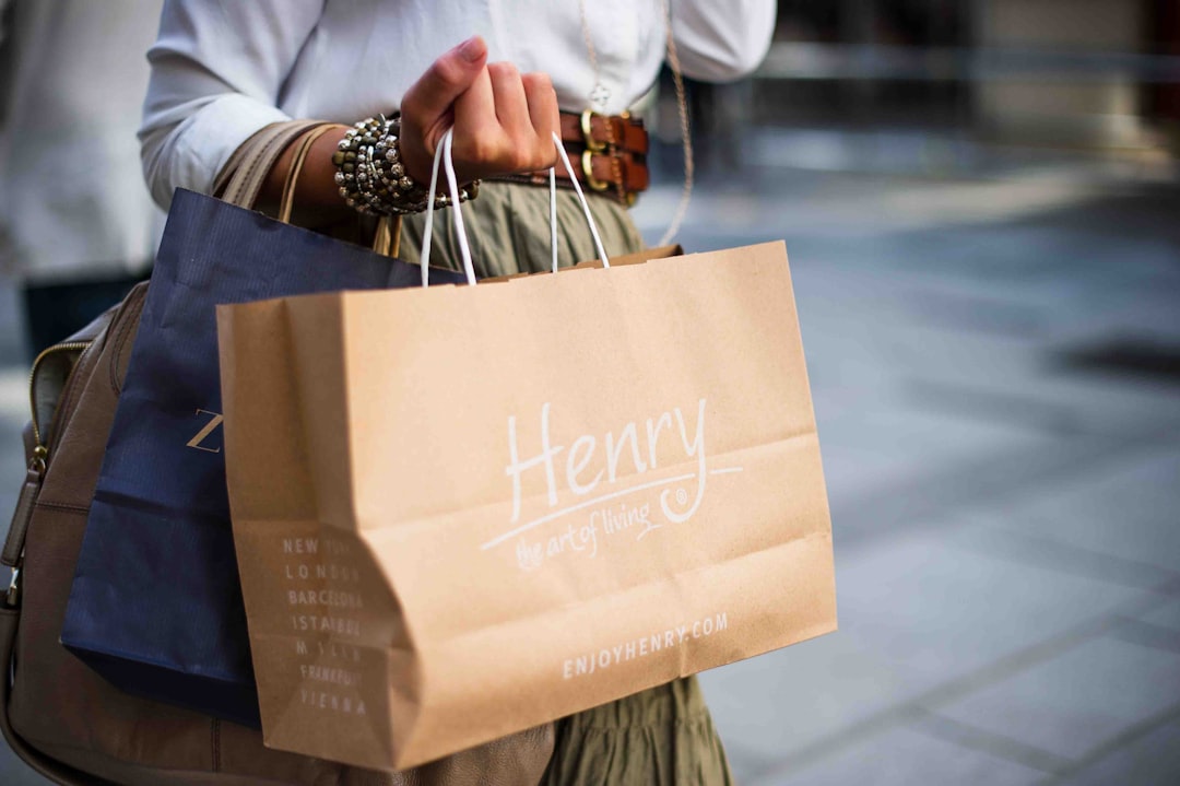 A woman walks along a New York City street carrying a bag of vintage clothing after a successful resale shopping trip