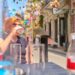 A woman staying hydrated on a New York City street, showing how to stay cool during July heat