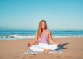 A woman practices yoga on a New York City waterfront pier as part of a heat-proof outdoor fitness routine in summer
