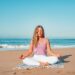 A woman practices yoga on a New York City waterfront pier as part of a heat-proof outdoor fitness routine in summer