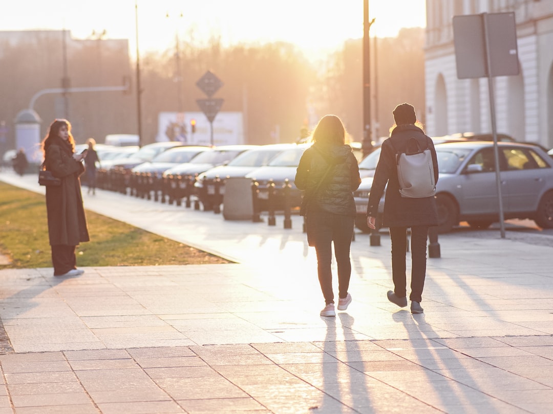 A woman enjoying a morning routine walk along a quiet New York City street at sunrise