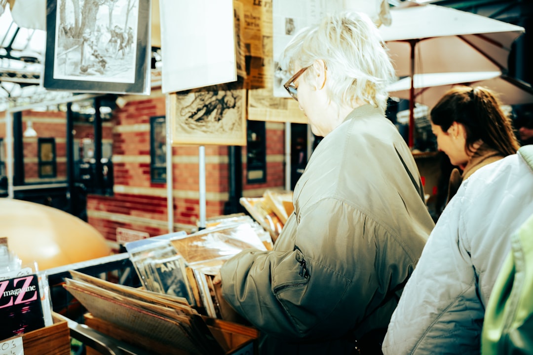 An art advisor reviewing an acquisition catalogue with a client, showing how professional art advisors help collectors.