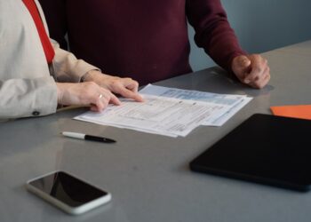 A small business owner reviews an employment contract before bringing on their first employee in New York City
