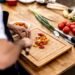 chef-plating-heirloom-tomato-salad-unsplash - NYCwebzine A chef carefully plates a vibrant heirloom dish featuring August tomatoes at a New York City farm-to-table restaurant.