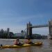 child-kayaking-river-city-unsplash - NYCwebzine A child paddling a kayak on the East River during a family kids adventure at Brooklyn Bridge Park in New York City