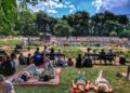 crowd-enjoying-outdoor-concert-park-unsplash - NYCwebzine A diverse crowd of people enjoying free outdoor concerts in a New York City park on a summer evening
