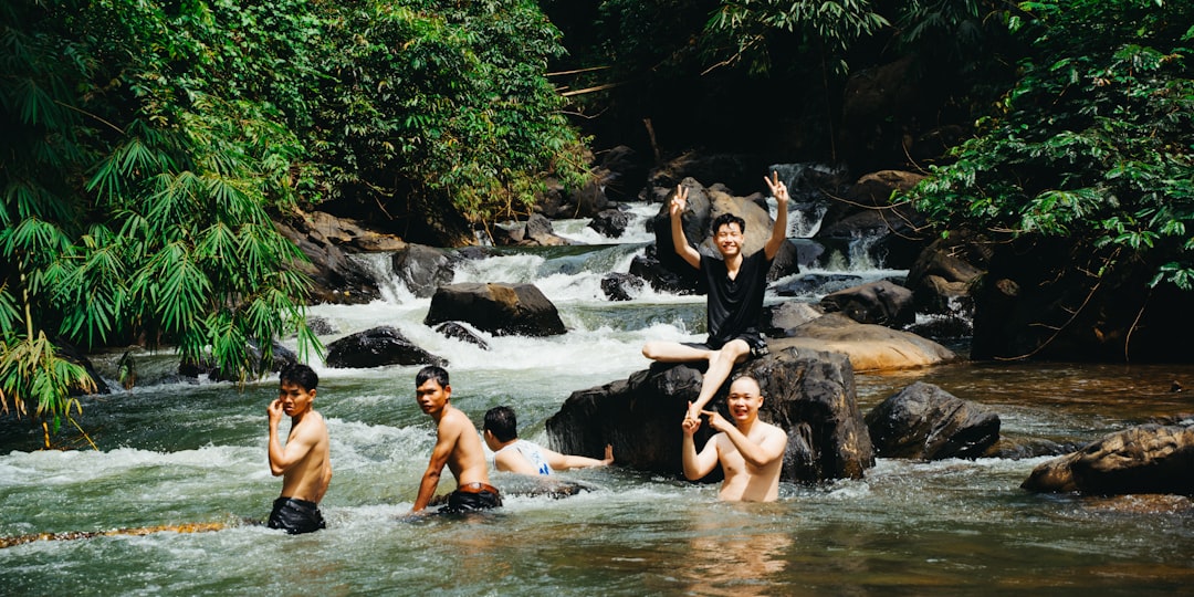 A group of friends resting beside a Catskills waterfall during an upstate escape long weekend