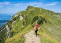 hiking-trail-woman-unsplash - NYCwebzine A woman hiking a forest trail in the Hudson Valley on an upstate escape from New York City