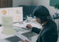 A financial analyst reviewing NYC REITs performance data on a screen in a Manhattan office