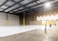 A small investor reviews documents inside a New York City storage units facility, assessing occupancy and returns data.