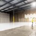 investor-reviewing-storage-facility-documents-unsplash - NYCwebzine A small investor reviews documents inside a New York City storage units facility, assessing occupancy and returns data.