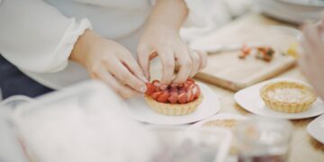 pastry-chef-plating-summer-dessert-unsplash - NYCwebzine A pastry chef carefully plates a late summer dessert at a New York City restaurant, showcasing seasonal fruit.