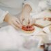 pastry-chef-plating-summer-dessert-unsplash - NYCwebzine A pastry chef carefully plates a late summer dessert at a New York City restaurant, showcasing seasonal fruit.